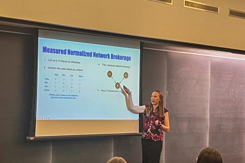 Hilary Bergsieker pointing to powerpoint slides on Normalized Network Brokerage