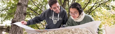 Two students looking together at a map.