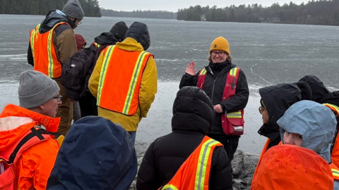 Jen Parks instructs students in the field.
