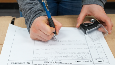 Student taking notes. 