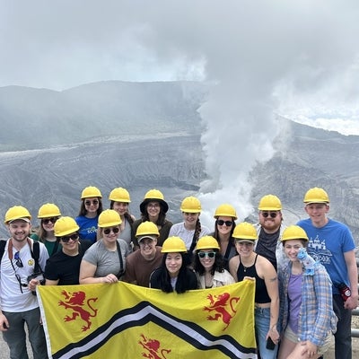 Students holding the University of Waterloo flag. 