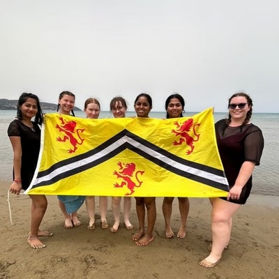 Students holding the University of Waterloo flag. 