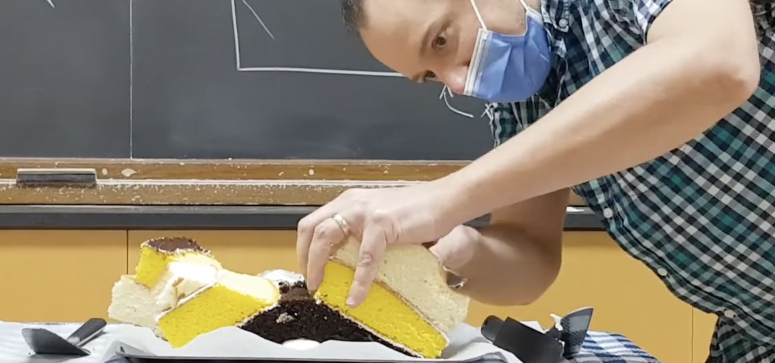 Man cutting layered cake.