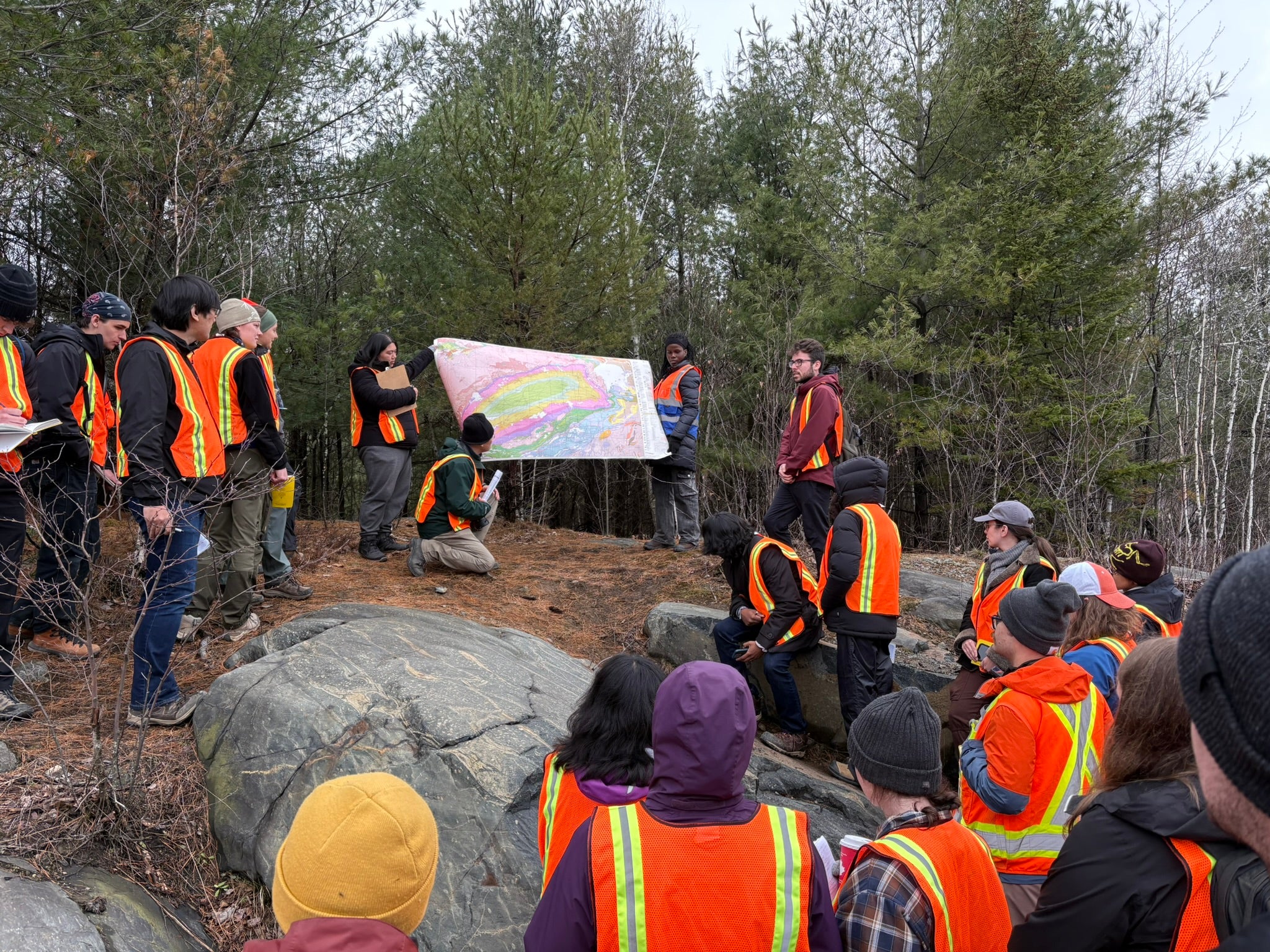A group of students studying a map on a field trip.
