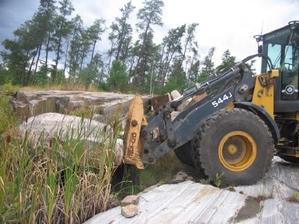 The rock being selected and carried by a bulldozer from French River, Ontario.