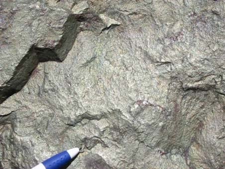 Chalcopyrite close up with a pen for scale.