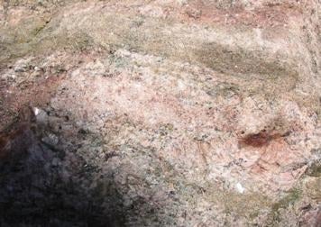 A closeup of the Granite Gneiss Boulder showing banding with large crystals of quartz and feldspar.