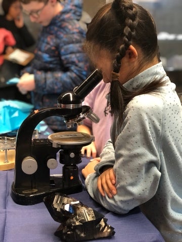 Girl looking into a microscope 