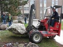 Jessie's rock being placed in the Peter Russell Rock Garden.