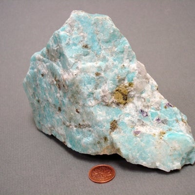 Amazonite next to a penny for size comparison