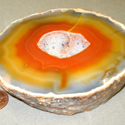 Brazilian agate next to a penny for size comparison
