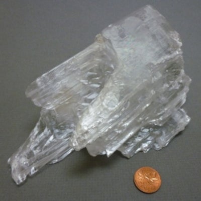 Gypsum sample next to a penny for size comparison