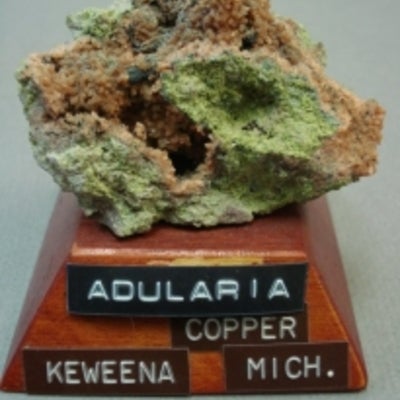 Adularia mineral mounted on a wood base with a label