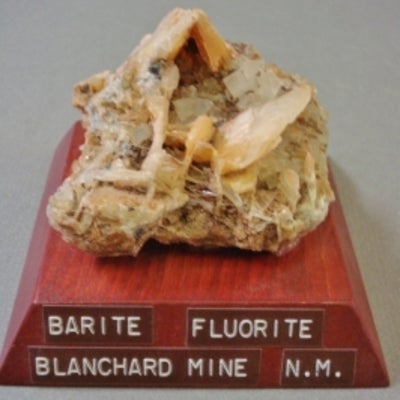 Baryte and fluorite mounted on a wood base with a label