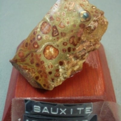 Bauxite mounted on a wood base with a label