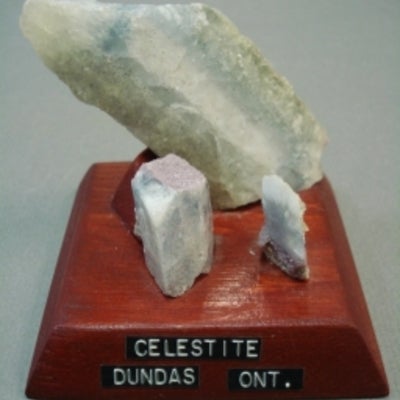 Celestite mounted on a wood base with a label