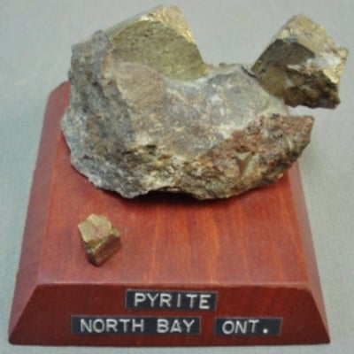 Pyrite mounted on a wood base with a label