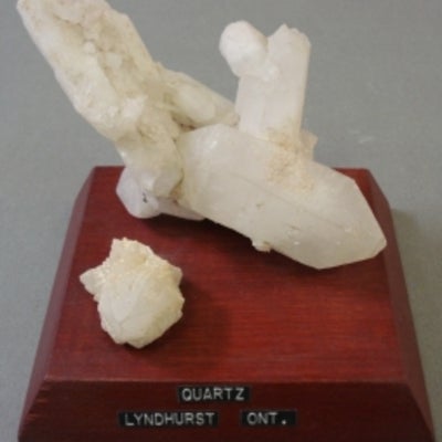 Quartz mounted on a wood base with a label