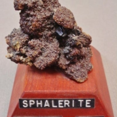 Sphalerite mounted on a wood base with a label