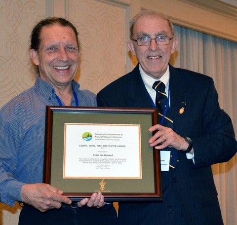 WSC Consultant Bill Clarke (BSc Earth Sciences '76; MSc '81) presents Peter Russell with his award.