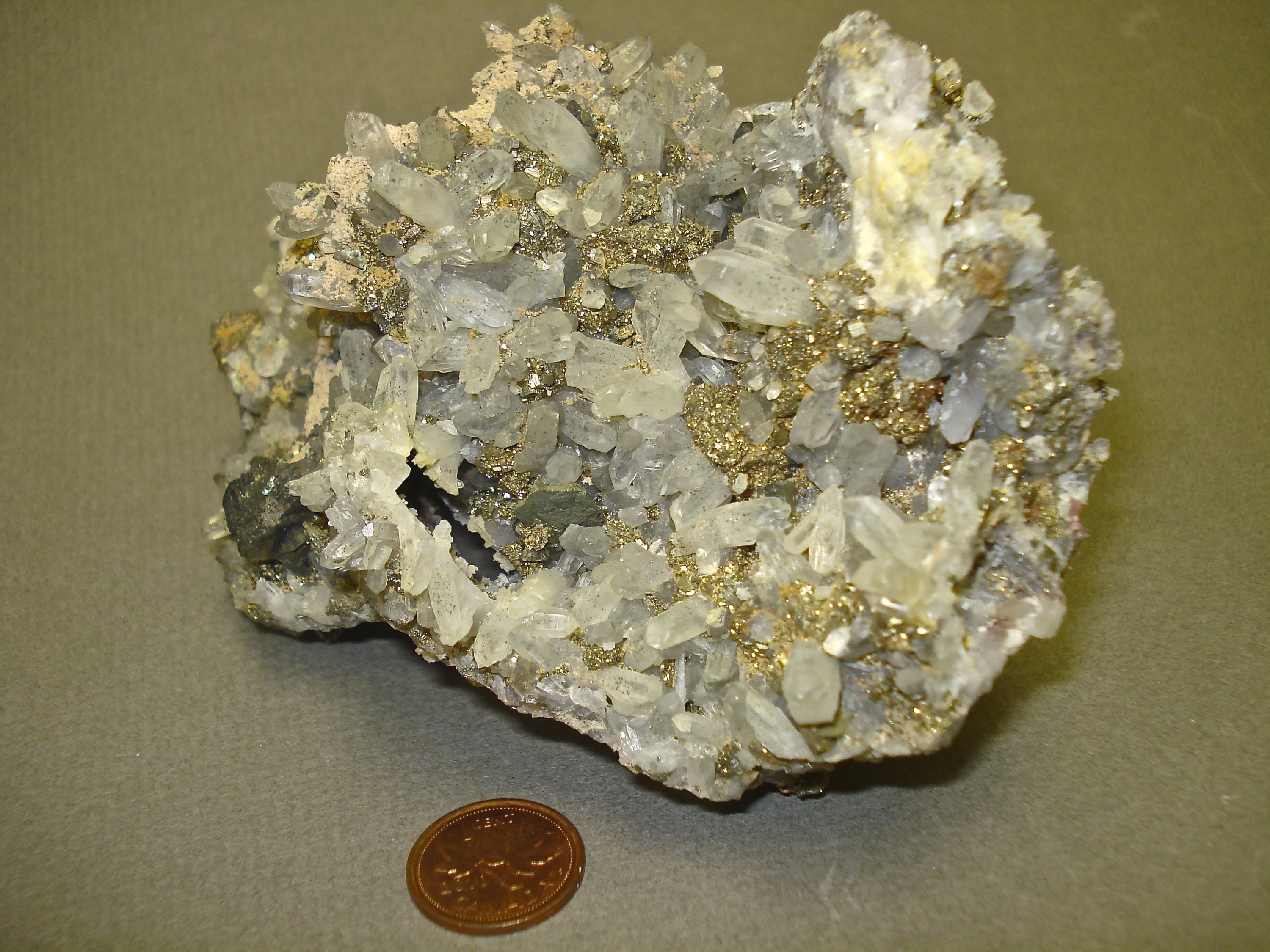 Chalcopyrite and Quartz next to a penny for size comparison