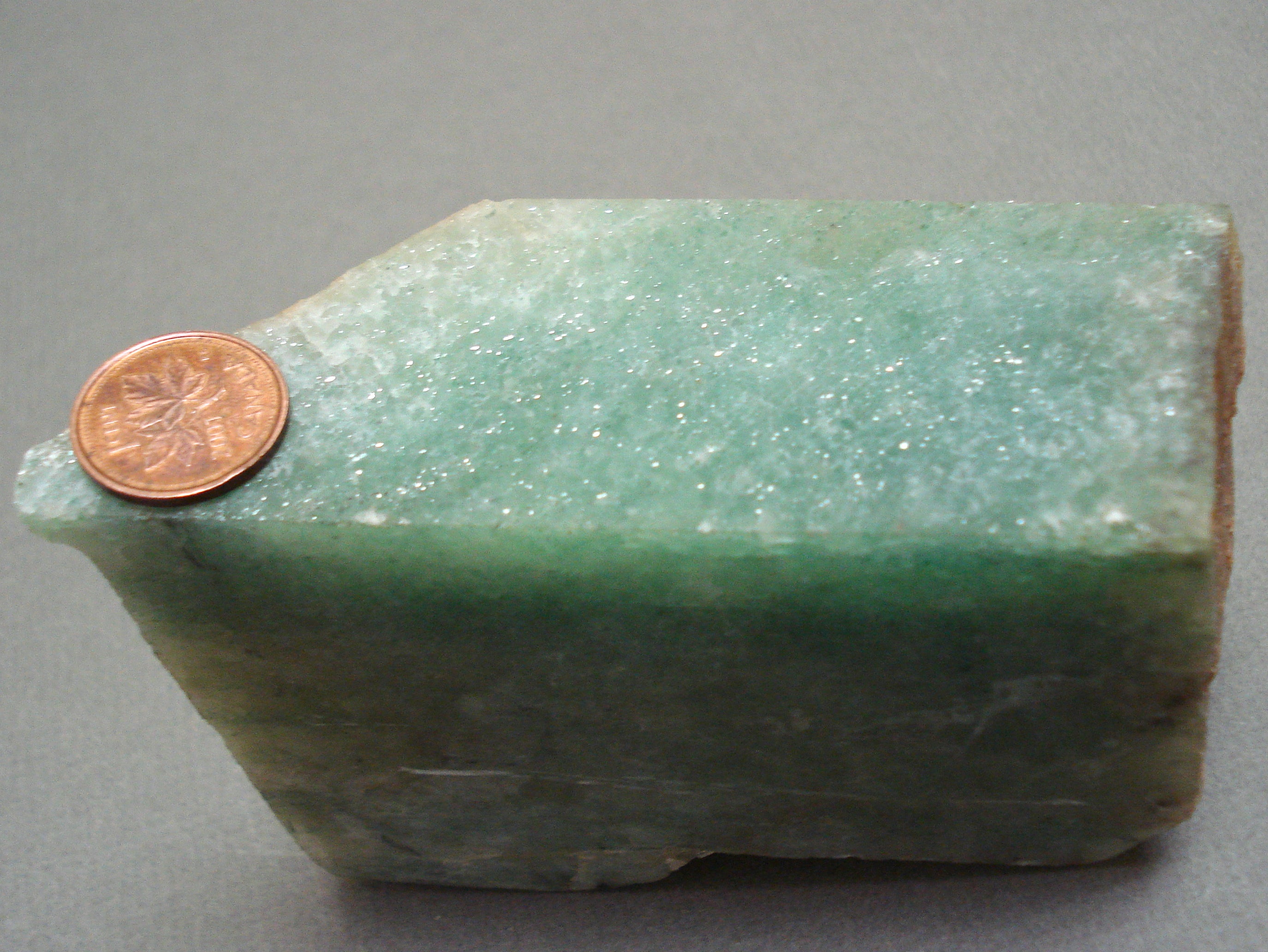 Algoma Jade next to a penny for size comparison