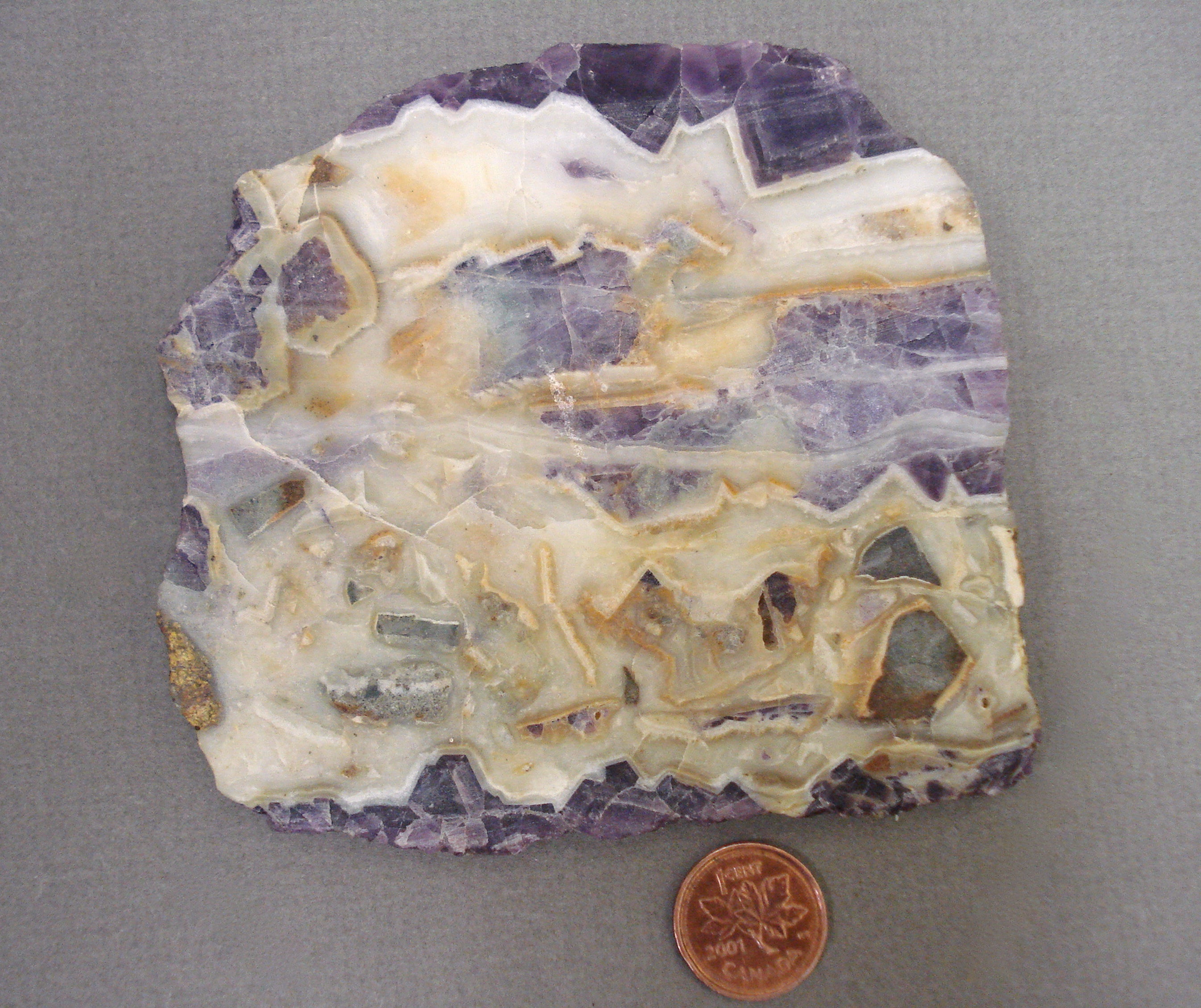 Quartz and Fluorite Slab next to a penny for size comparison