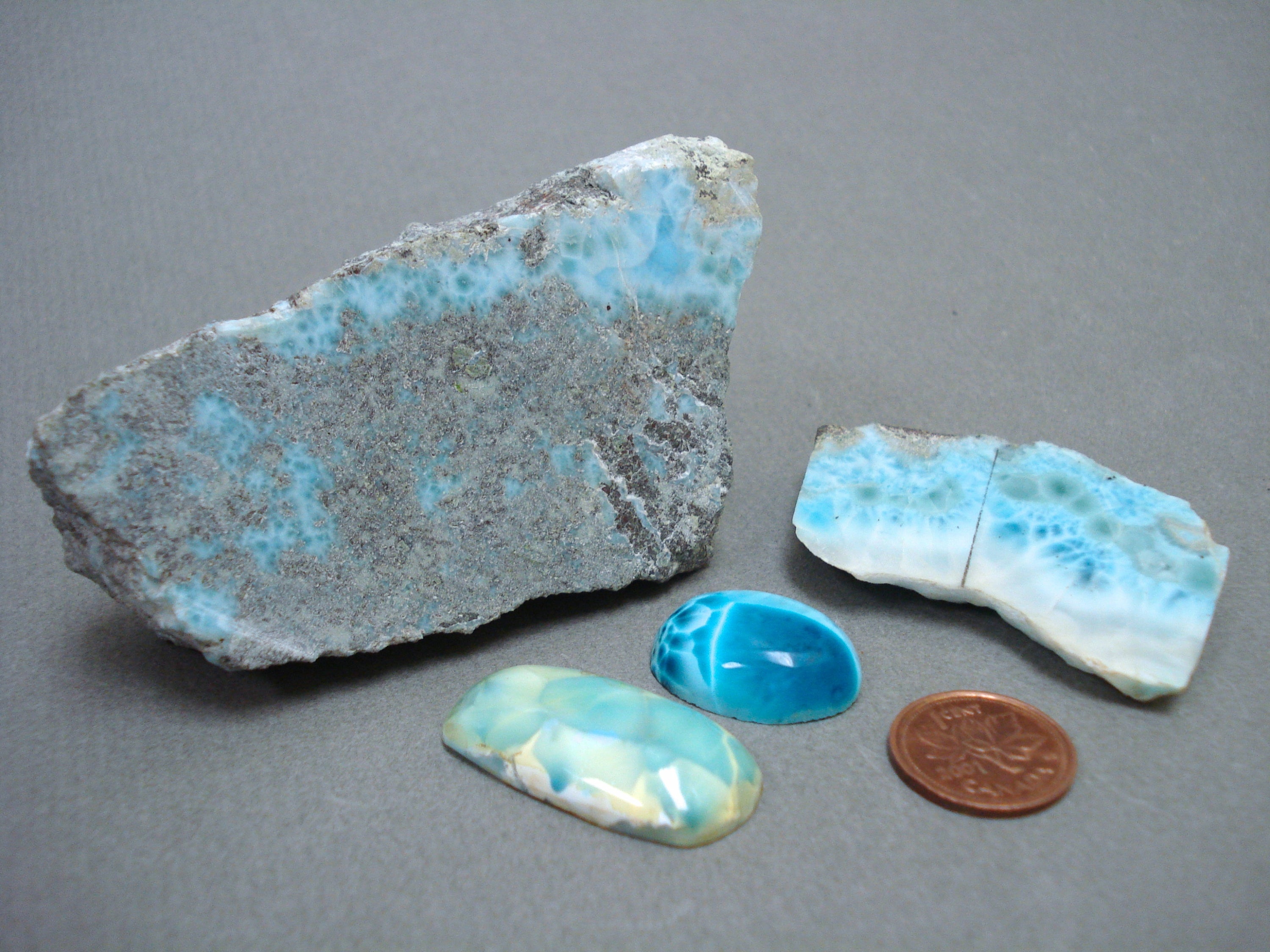Larimar next to a penny for size comparison