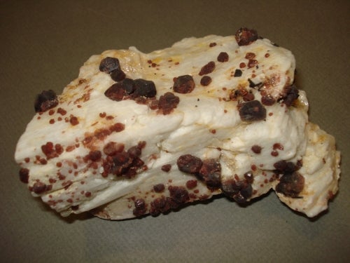 dark red garnet crystals in white rock matrix