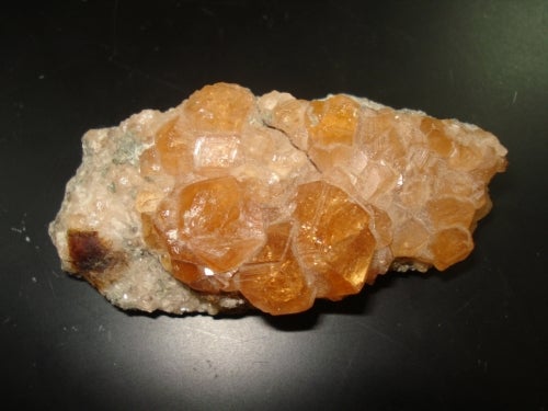 orange garnet crystals in asbestos matrix