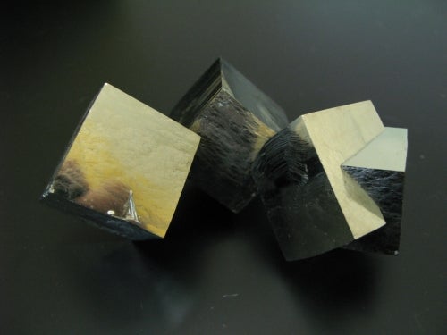three cubes of gold-coloured pyrite