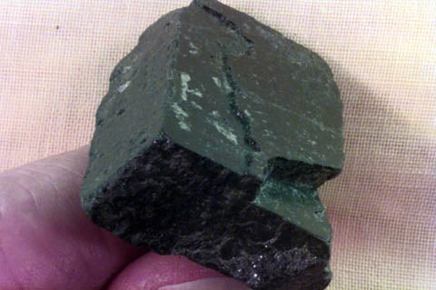 black piece of pyroxene exhibiting ninety degree cleavage