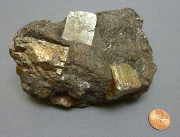 talc, tourmaline, and pyrite Madoc next to a penny for size comparison
