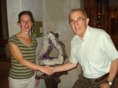 Peter Russell shaking hands with artist in front of piece of work