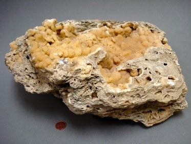 Piece of yellow calcite with an undulating surface