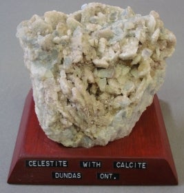Celestite with calcite mounted on a wood base with a label