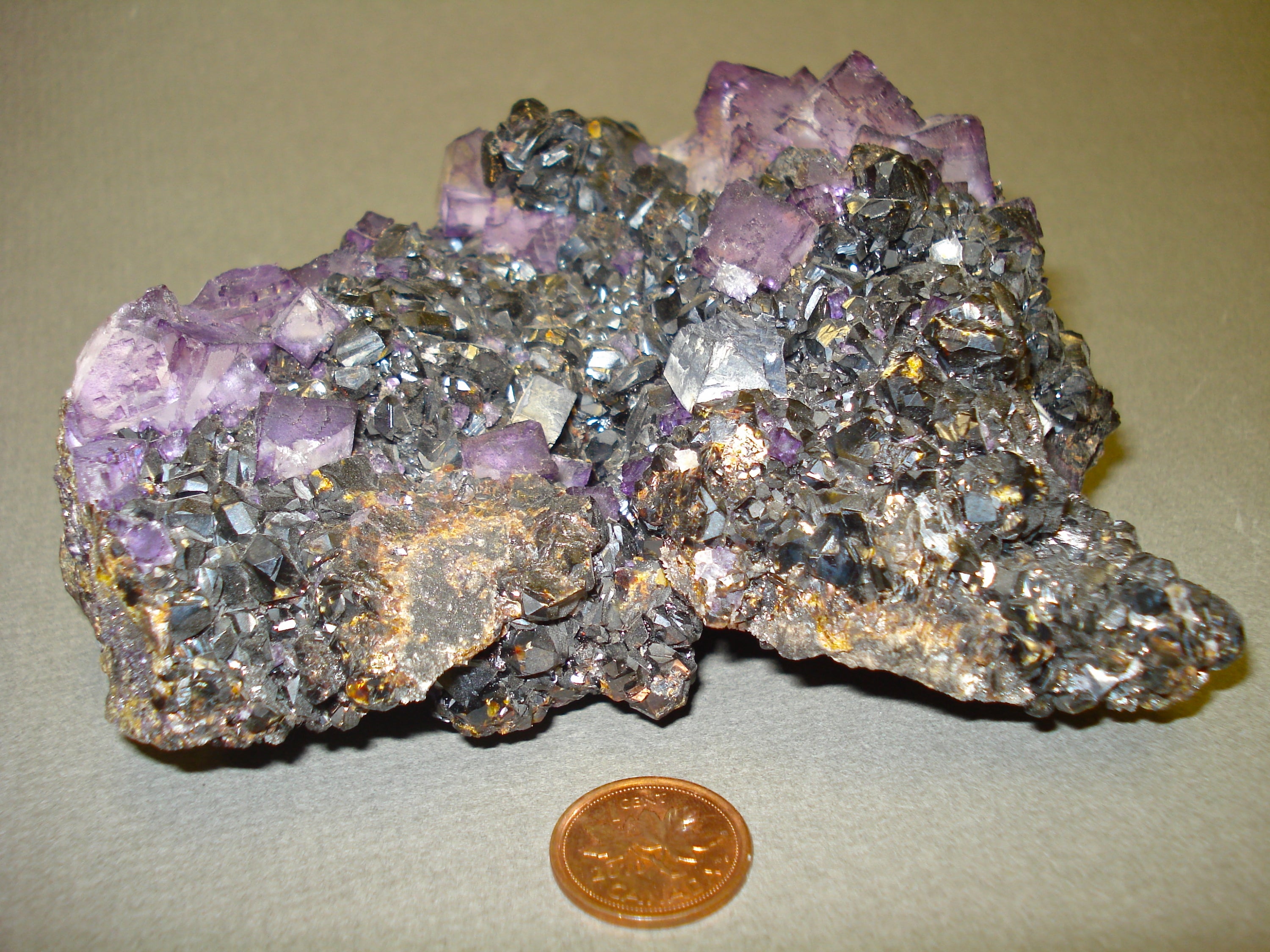 Fluorite, Galena and Sphalenite next to a penny for size comparison