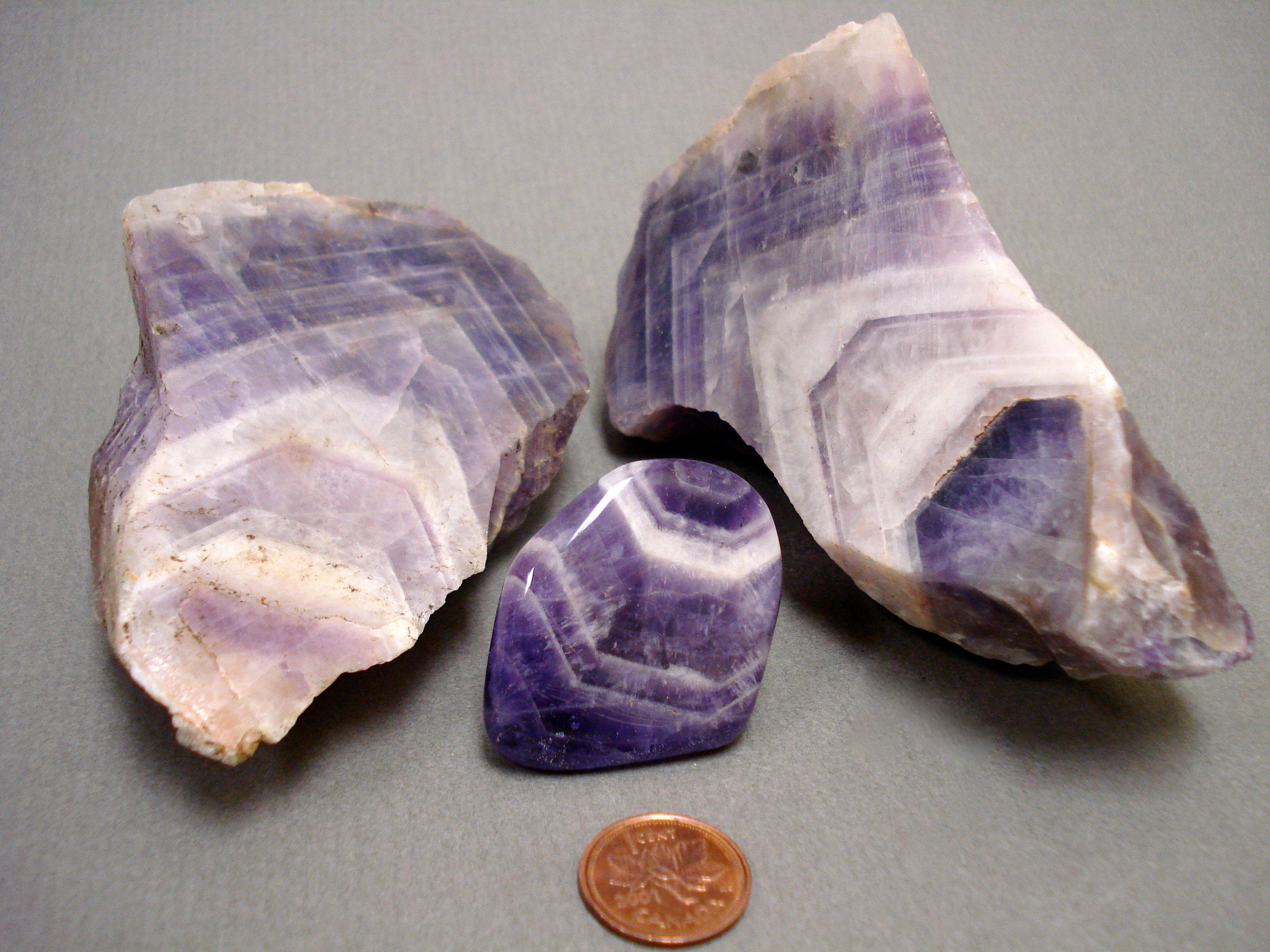 Chevron Amethyst next to a penny for size comparison