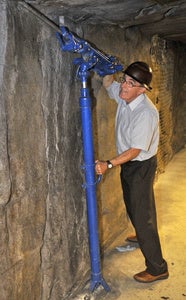 man pretending to drill into ceiling