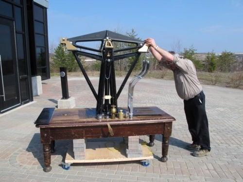 weigh scale with man beside it to demonstrate its size