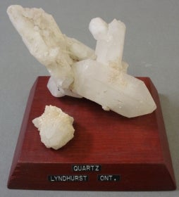 Quartz mounted on a wood base with a label