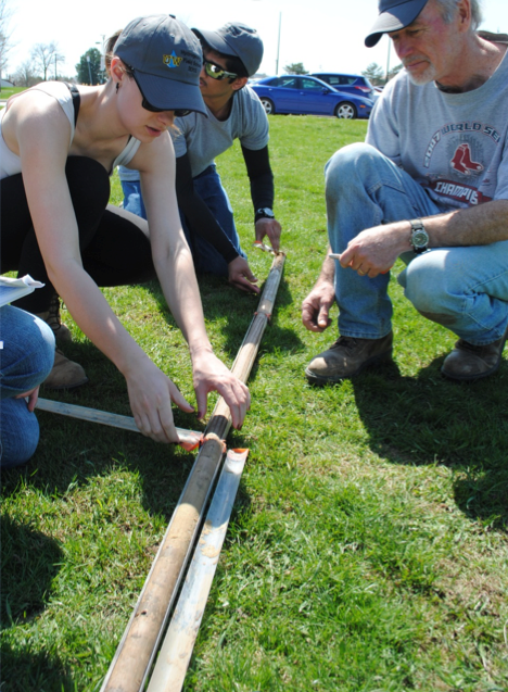 Girl examining a soil core at Waterloo.