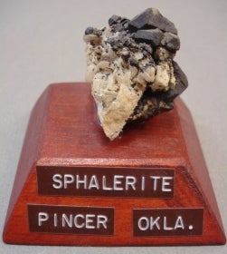 Sphalerite mounted on a wood base with a label
