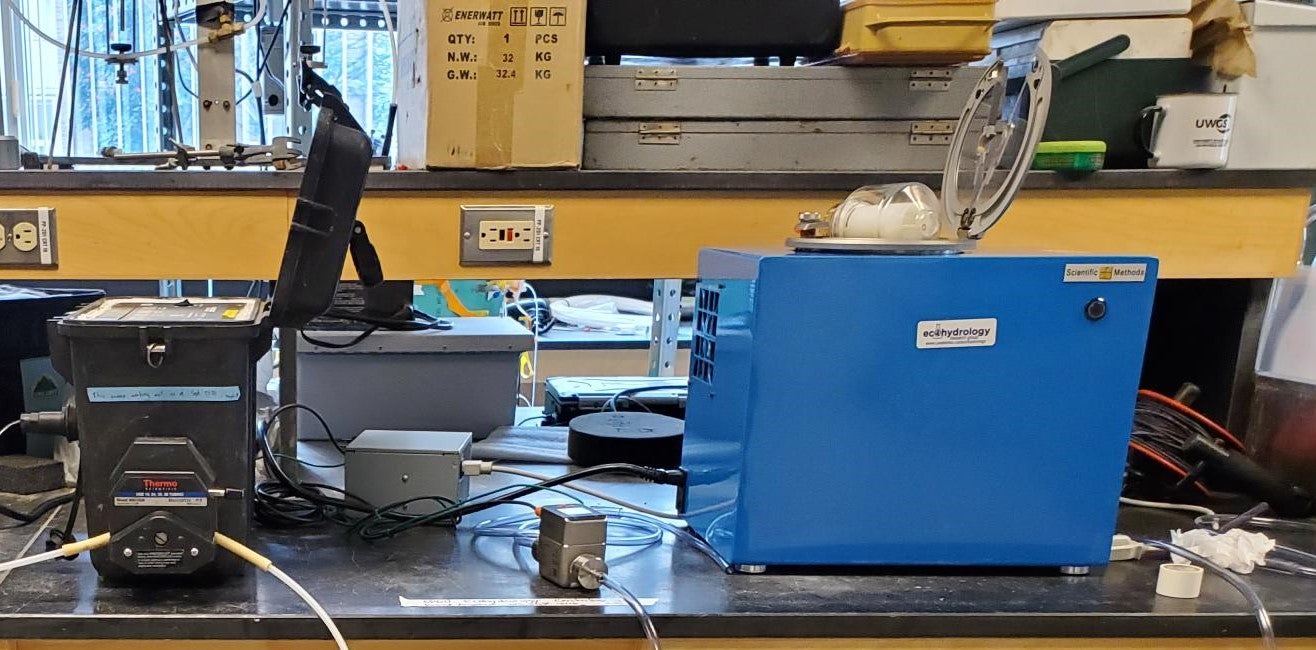 peristaltic pump connected with tubing to centrifuge box on bench top