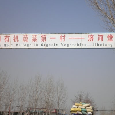 Sign saying "China's No.1 Village in Organic Vegetables - Jihetang"