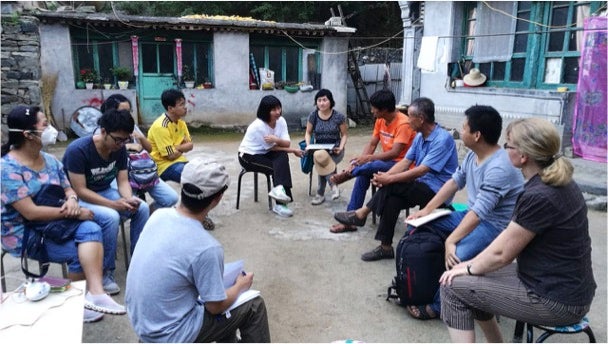 Steffanie and Zhenzhong talking to farmers from Baoshi village who participated in the nested market project