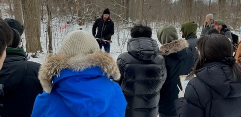 Students observing how to take a soil sample