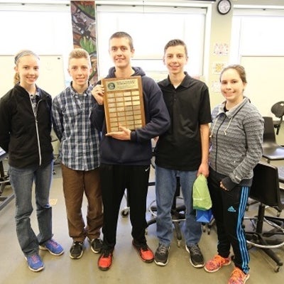 Students posing with an award