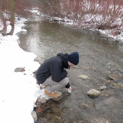 Student collecting water sample