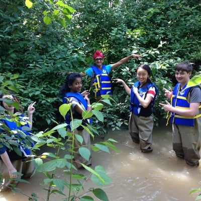 Students in waders and lifejackets in Laurel Creek